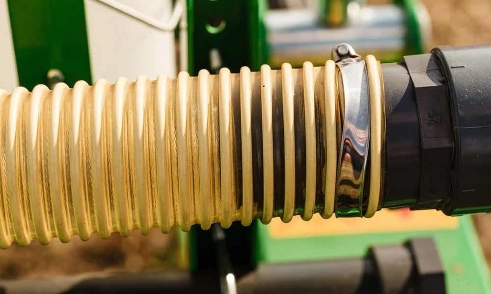 A yellow and clear spiral ducting hose attached to a black part.