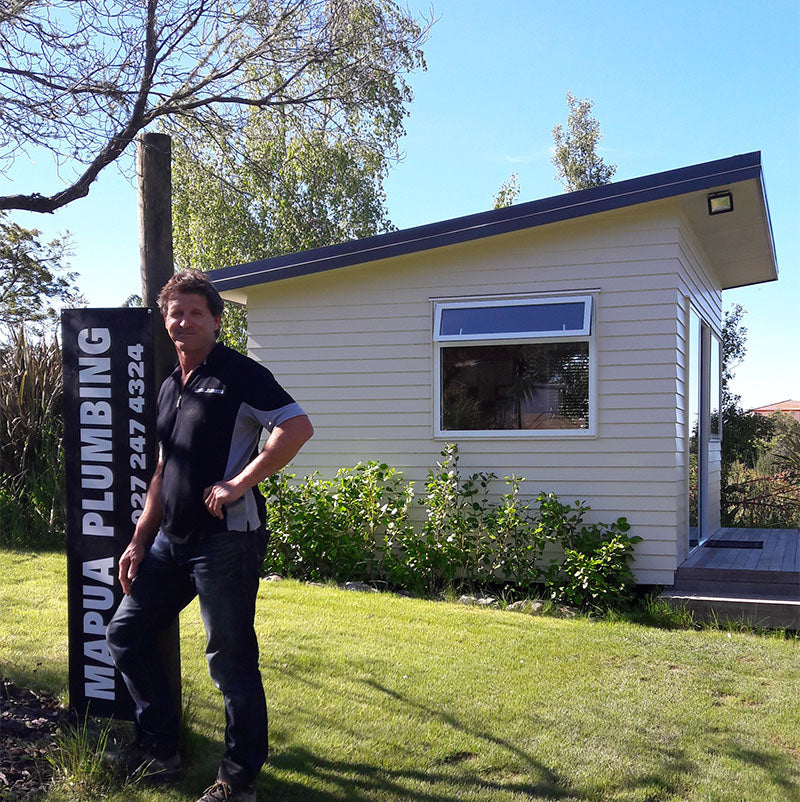 Plumber Sean Huxford standing outside the building that houses Mapua Plumbing.