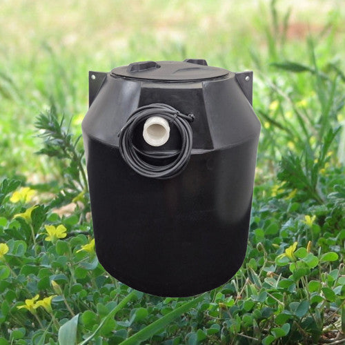 Black plastic pump chamber on a background of grass and stones