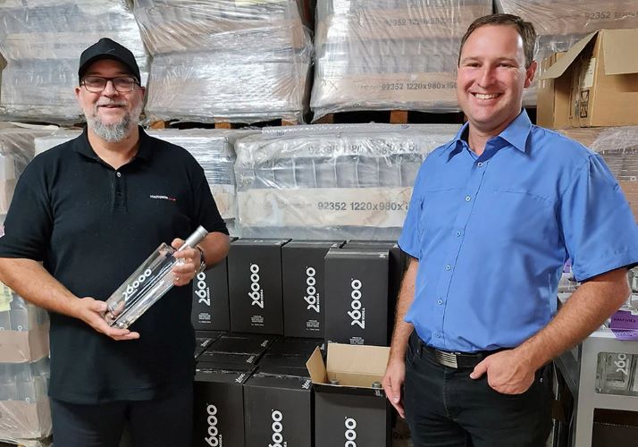Mark Vinsen and Jacob Lewis stand in front of boxes of 26000 Vodka.