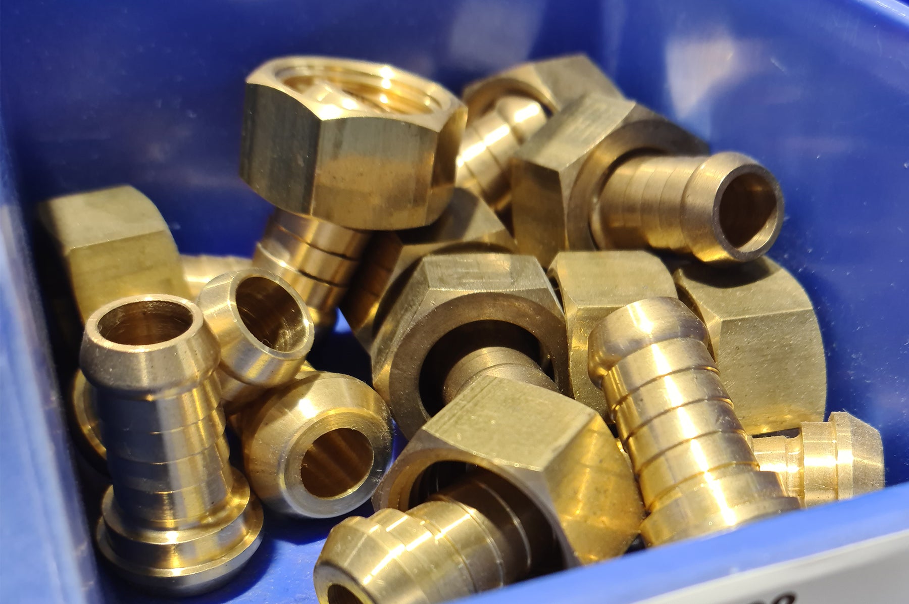 Brass fittings in a blue display case. 