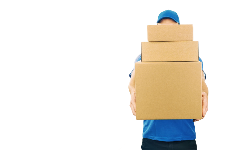 A person in a blue cap and shirt carrying three cardboard boxes.